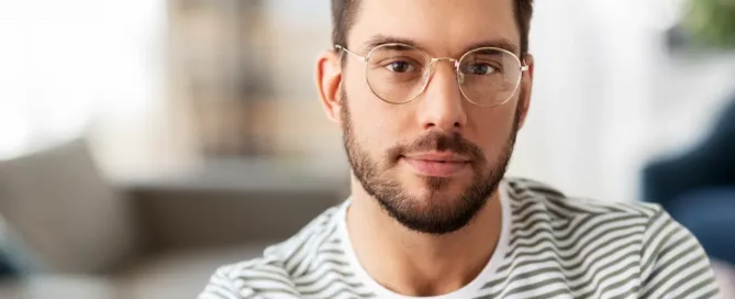 Friendly man with glasses looking into the camera