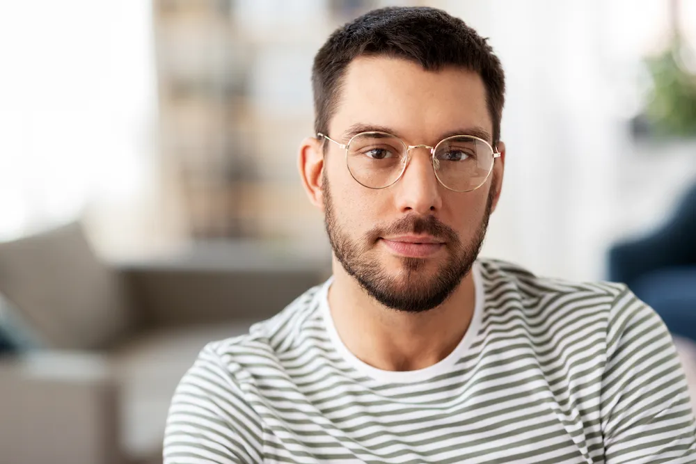 Friendly man with glasses looking into the camera