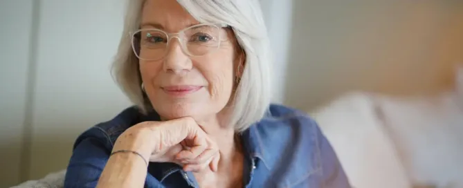 Smiling woman with glasses at an ophthalmology clinic