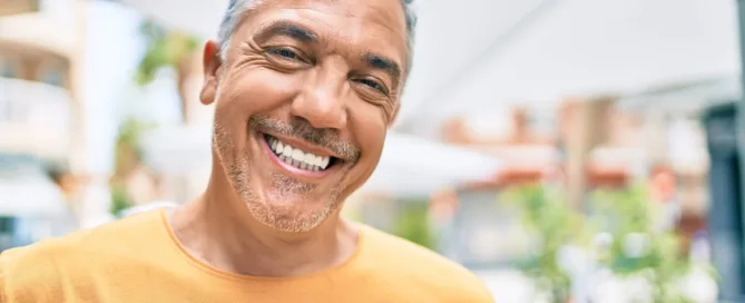 A man smiling with a friendly expression, casually dressed