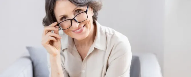 Smiling woman with glasses at an ophthalmology clinic