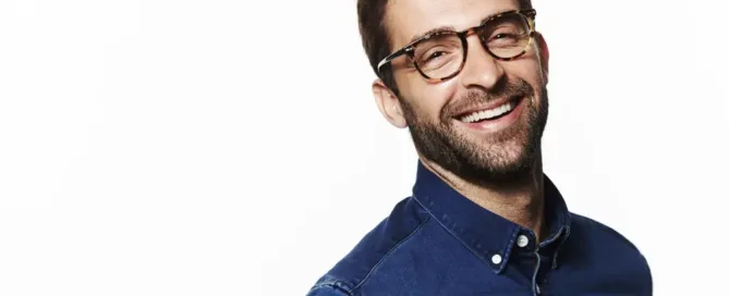 Smiling man with glasses at an ophthalmology clinic