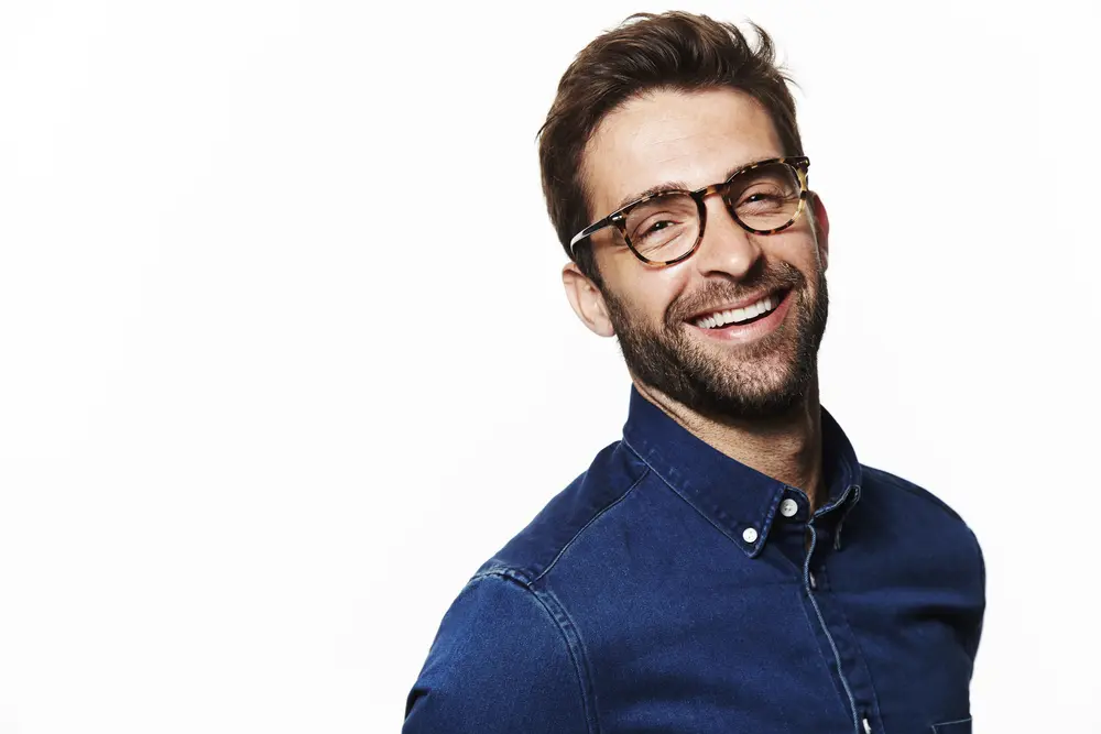 Smiling man with glasses at an ophthalmology clinic